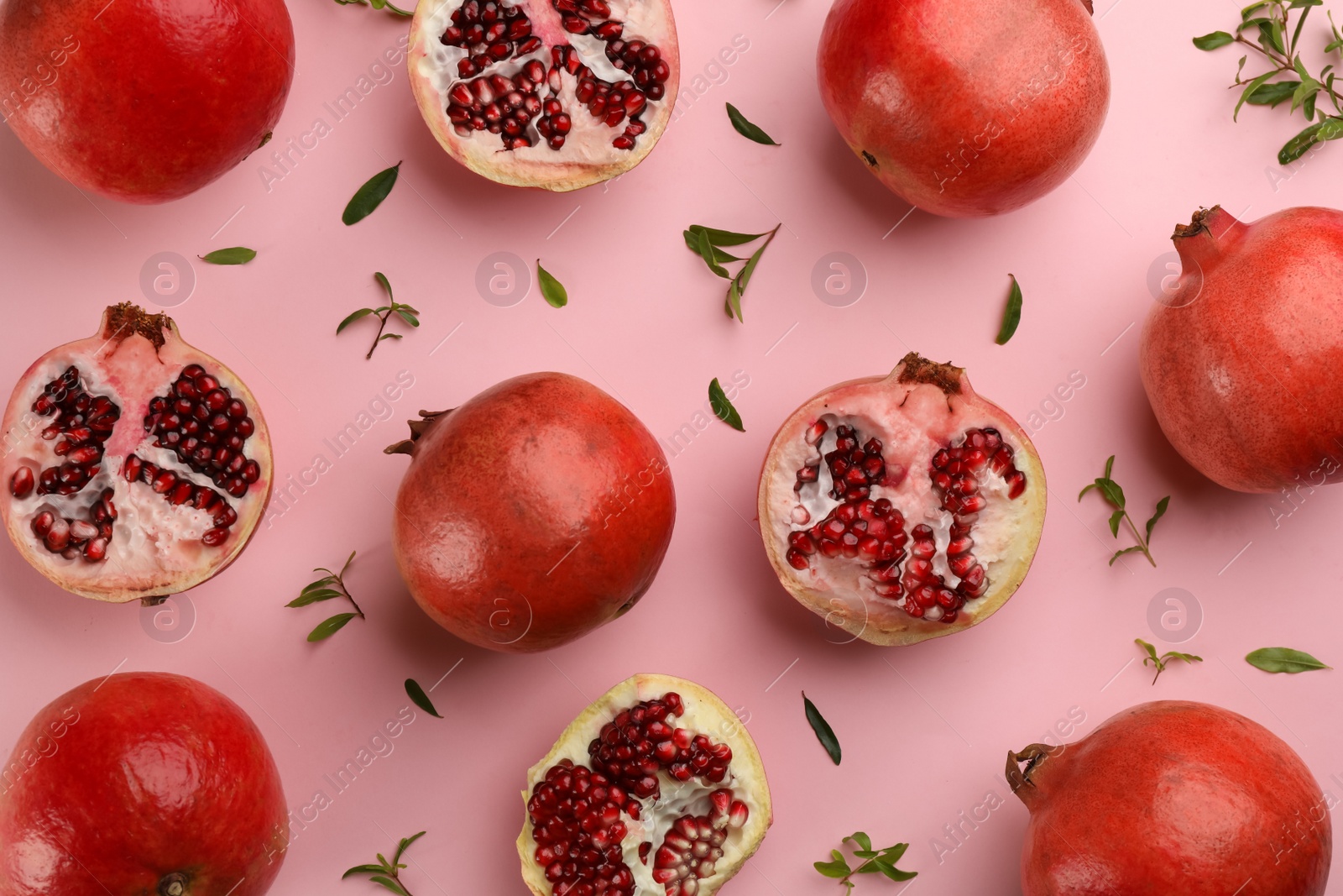 Photo of Flat lay composition with ripe pomegranates on pink background