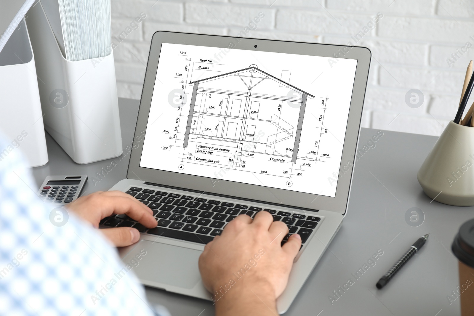 Image of Architect making project of house on laptop in office, closeup