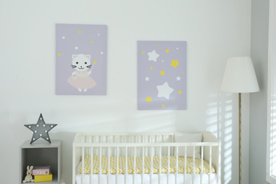 Stylish baby room interior with crib and cute wall art