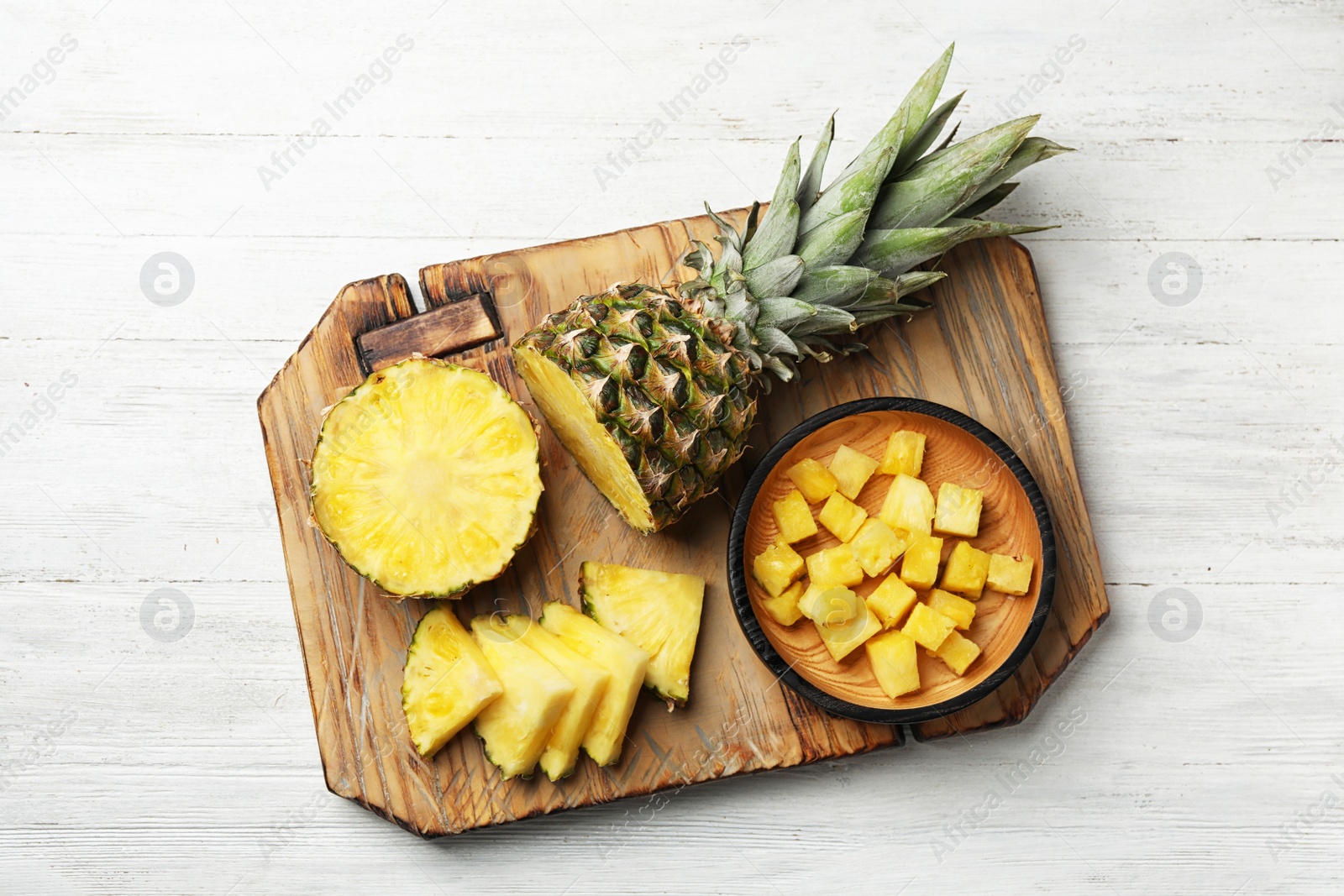 Photo of Flat lay composition with cut fresh juicy pineapple on wooden table