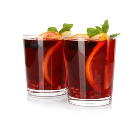 Photo of Aromatic Sangria drink in glasses isolated on white