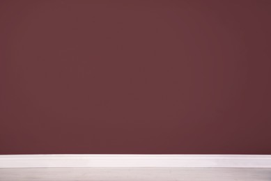 Photo of Blank burgundy wall in room. Space for design