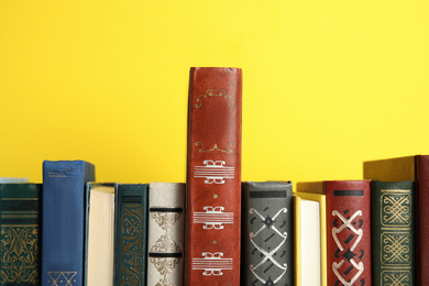 Photo of Collection of old books on yellow background