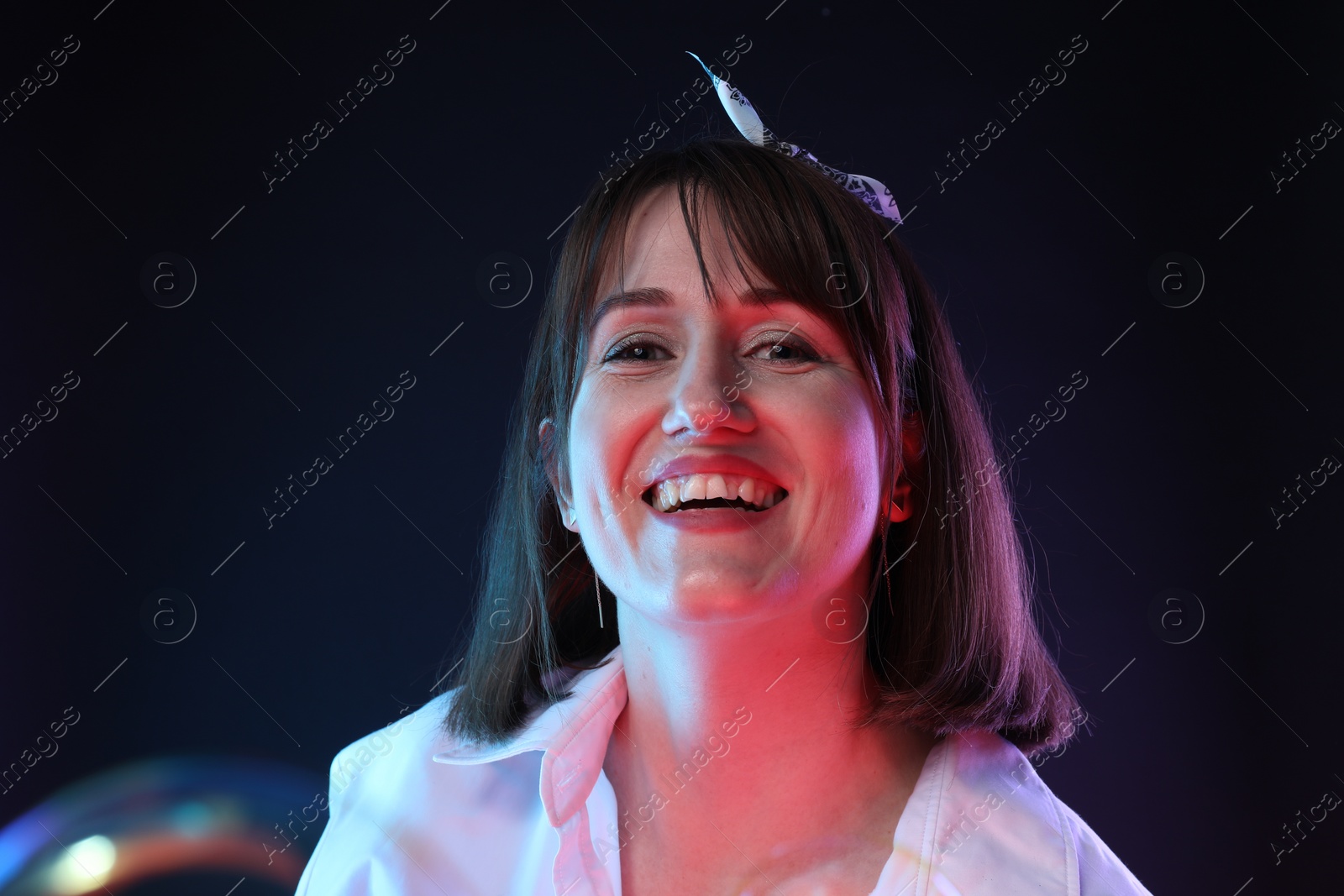 Photo of Portrait of happy woman and bubble on dark background