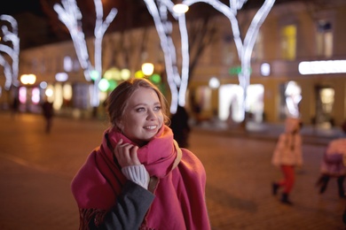 Photo of Beautiful young woman spending time in city at night