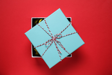 Beautiful gift box on red background, top view