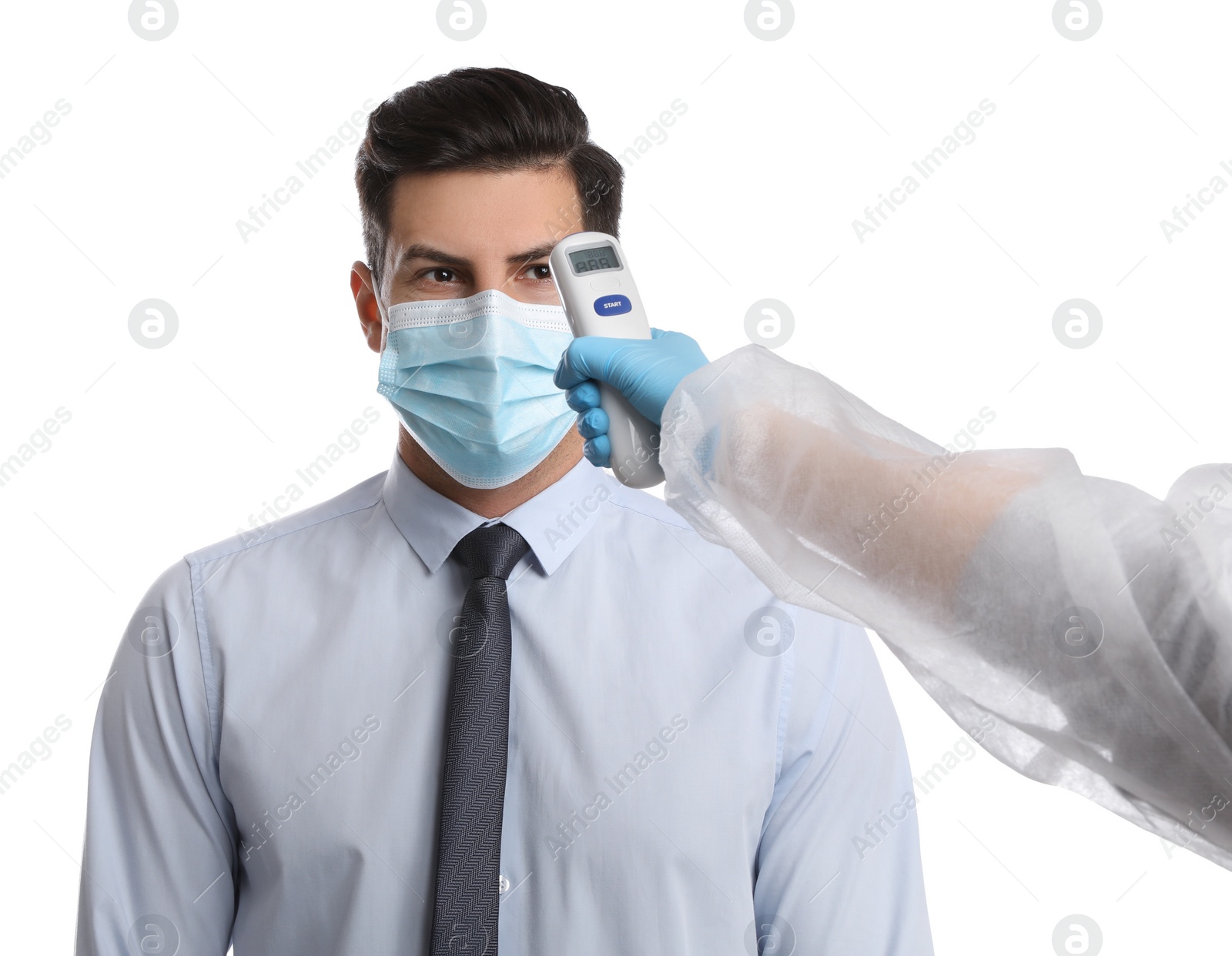 Photo of Doctor measuring man's temperature on white background, closeup. Prevent spreading of Covid-19