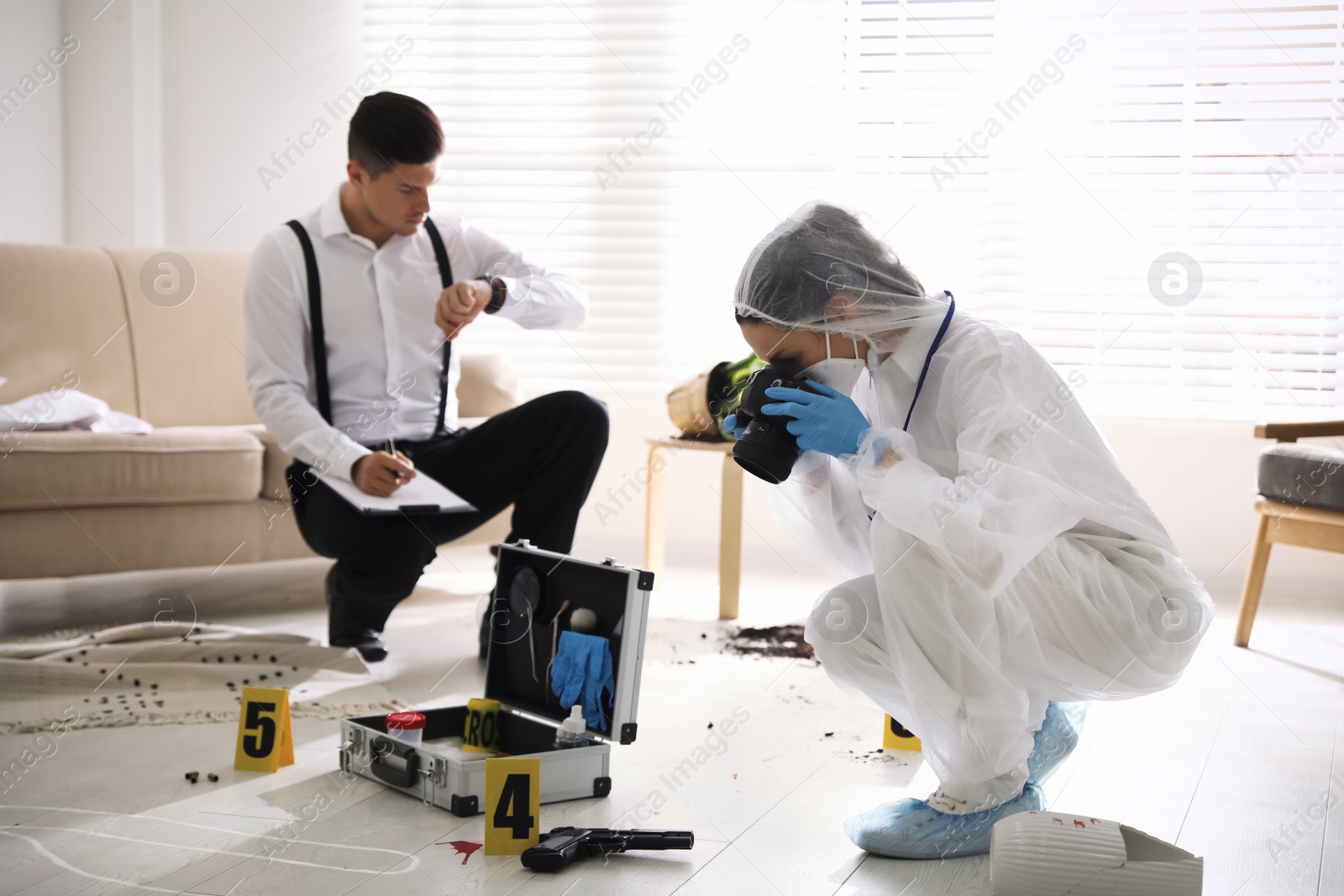 Photo of Investigators working at crime scene in living room