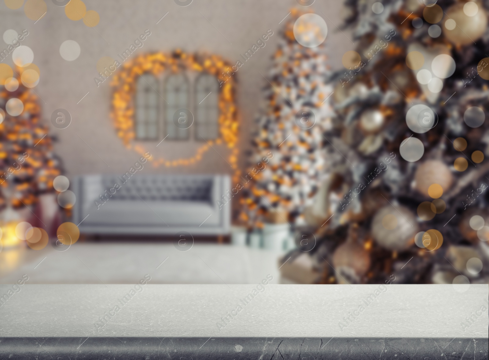 Image of Empty stone surface and blurred view of room decorated for Christmas