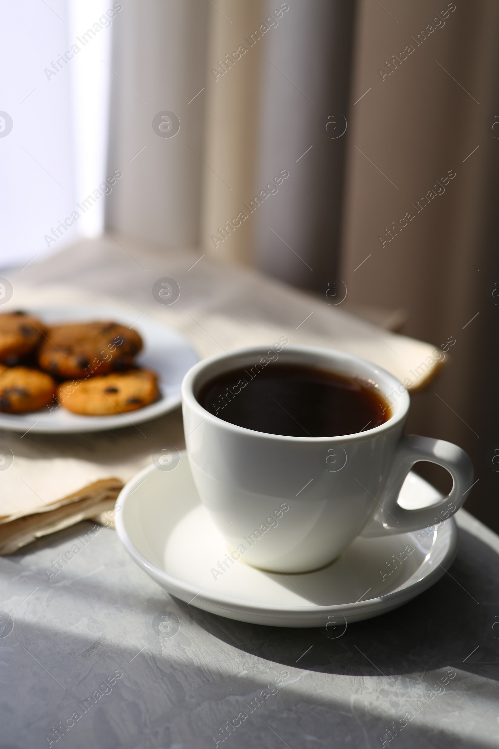 Photo of Delicious coffee, cookies and newspaper on table. Good morning