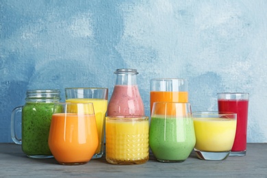 Glassware with delicious detox smoothies on table