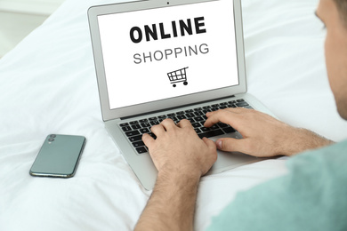 Man using modern laptop for online shopping during quarantine, closeup. Delivery service