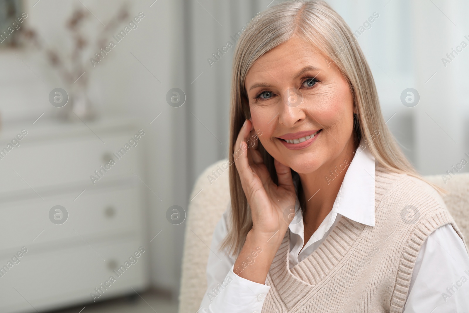 Photo of Portrait of beautiful middle aged woman at home, space for text