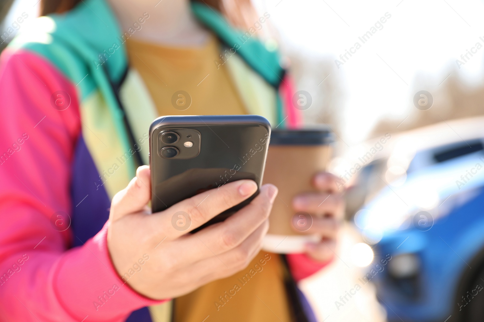 Photo of MYKOLAIV, UKRAINE - MARCH 16, 2020: Woman holding iPhone 11 Black outdoors, closeup