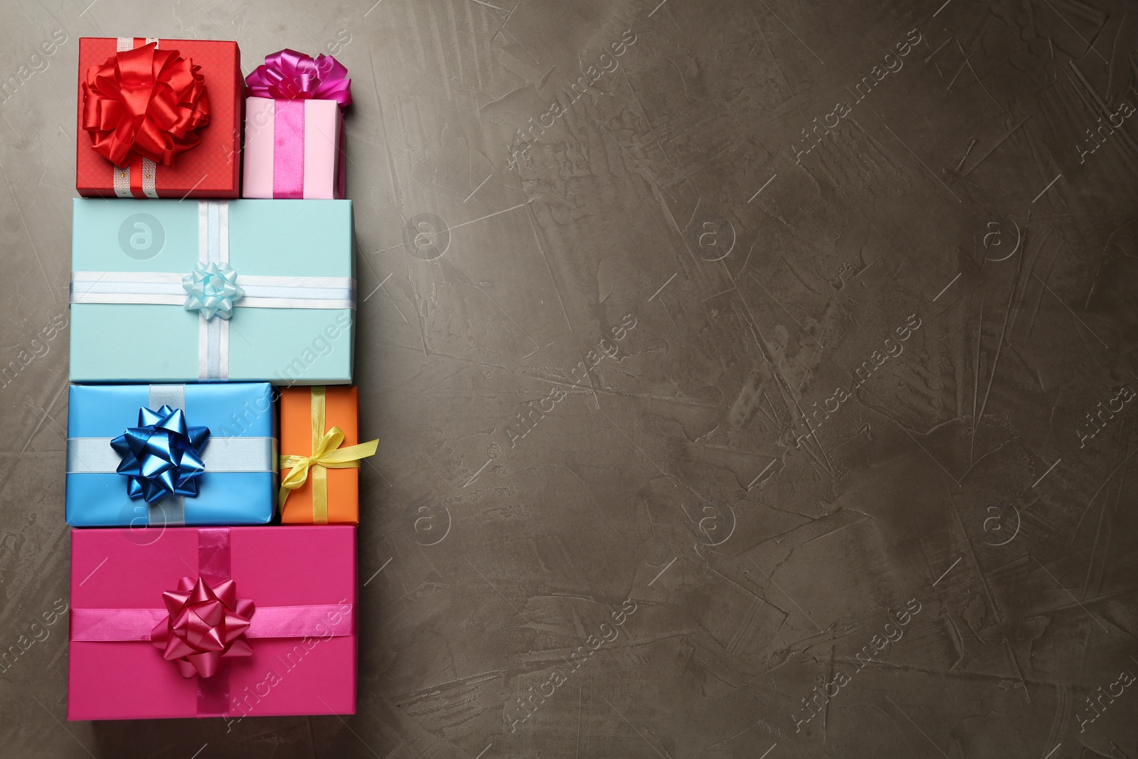 Photo of Many colorful gift boxes on grey table, flat lay. Space for text