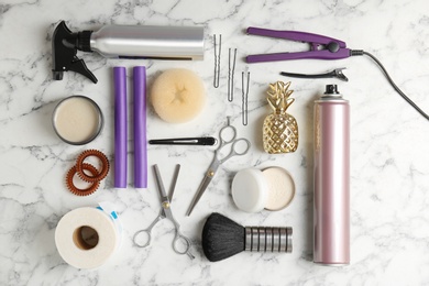 Photo of Flat lay composition with professional hairdresser tools on marble background