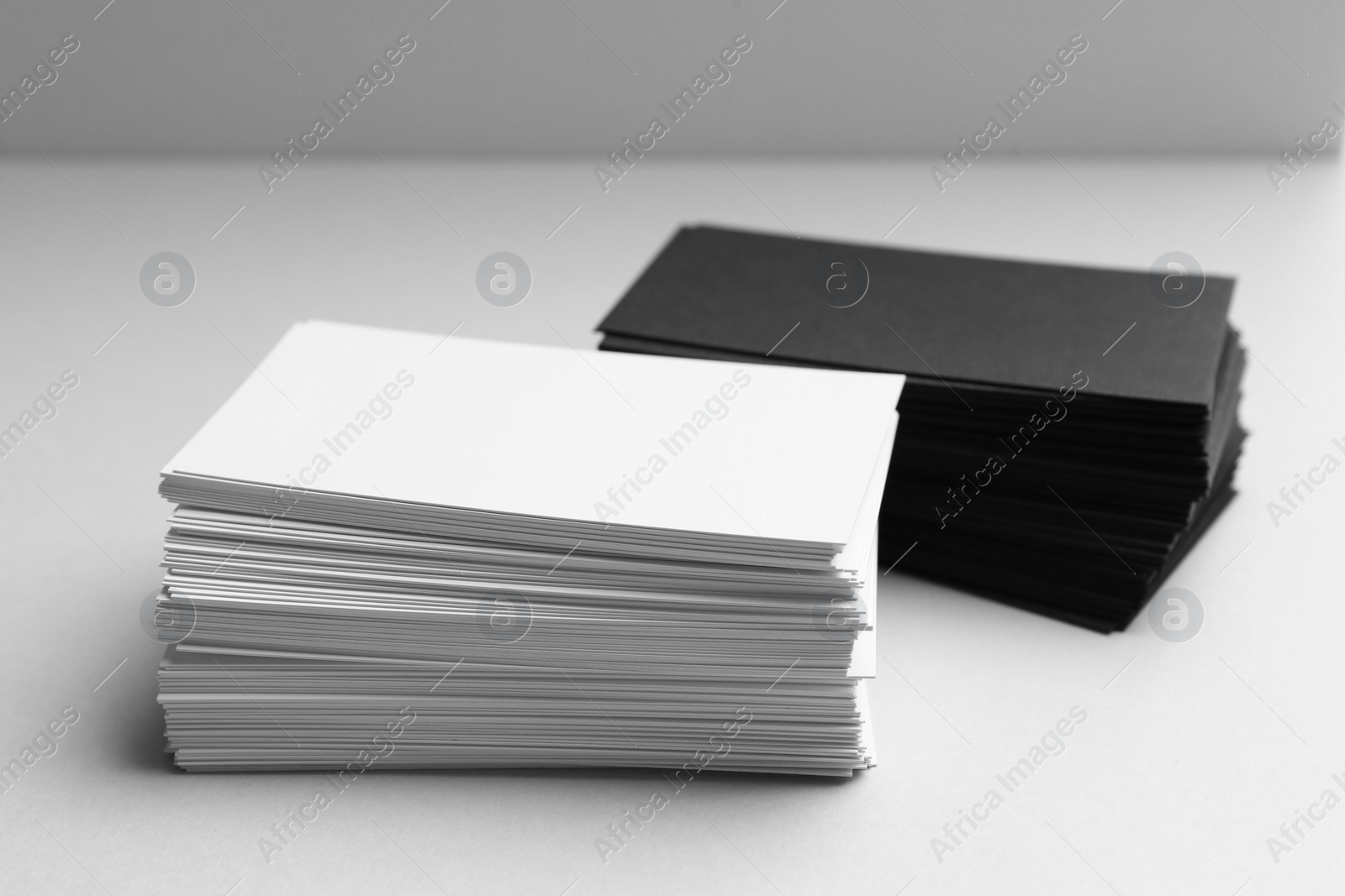 Photo of Blank business cards on white background, closeup. Mockup for design