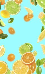 Image of Fresh juicy citrus fruits and green leaves falling on cyan background