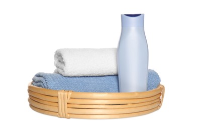 Photo of Wicker basket with folded soft terry towels and cosmetic product on white background