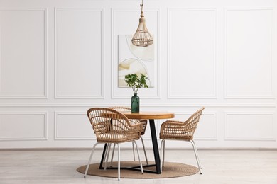 Dining room interior with comfortable furniture and green branches