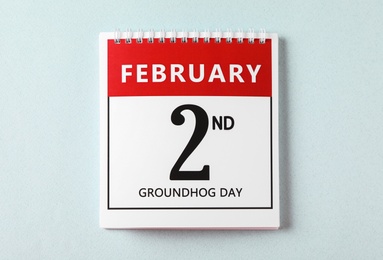 Photo of Top view of calendar with date February 2nd on light background. Groundhog day