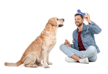 Photo of Happy man playing with his cute Labrador Retriever on white background