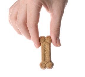 Photo of Woman holding bone shaped dog cookie on white background, closeup