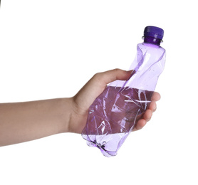 Photo of Woman holding crumpled bottle on white background, closeup. Plastic recycling