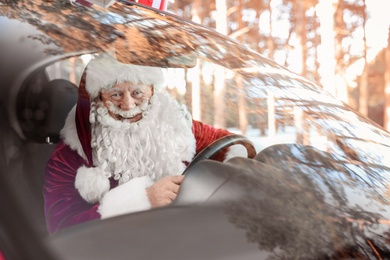 Authentic Santa Claus in car, view through windshield