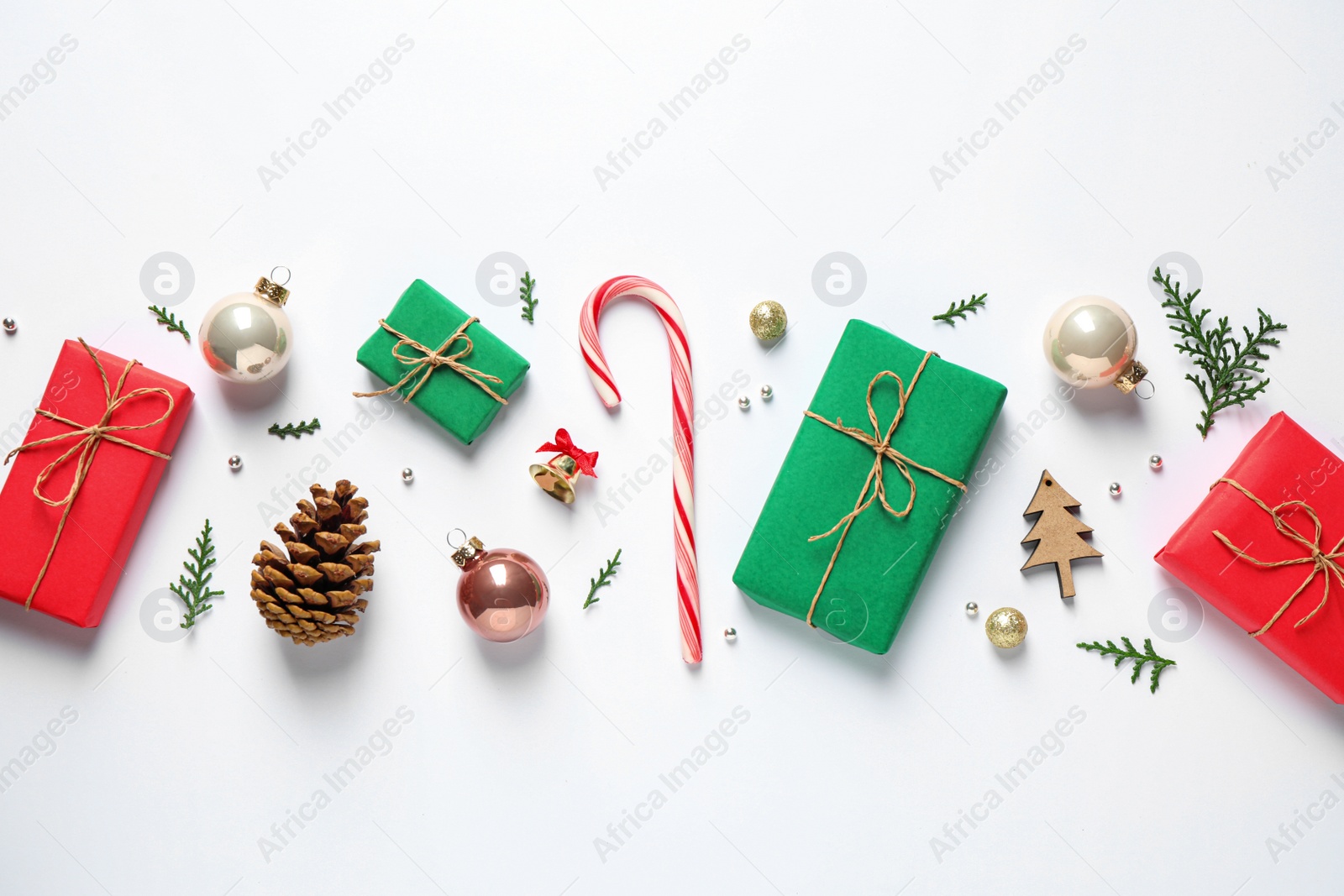 Photo of Flat lay composition with Christmas gifts and festive decor on white background