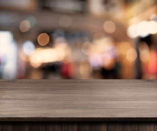 Image of Empty wooden surface and blurred view of clothes store interior. Space for design