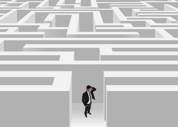 Image of Thoughtful businessman trying to find way out of maze
