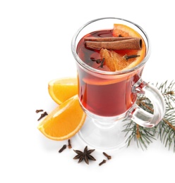 Photo of Glass cup of mulled wine with fir branch, cinnamon and orange isolated on white