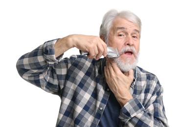 Photo of Senior man trimming mustache on white background