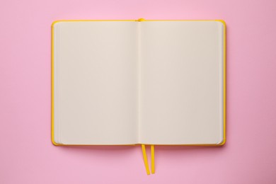 Photo of Blank notebook on pale pink background, top view
