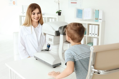 Ophthalmologist examining little boy in clinic