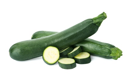 Cut and whole green ripe zucchini isolated on white