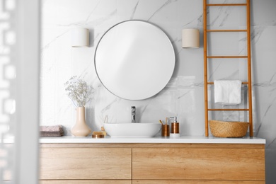 Modern bathroom interior with stylish mirror and vessel sink