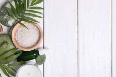 Photo of Flat lay composition with candle and different spa products on white wooden table. Space for text