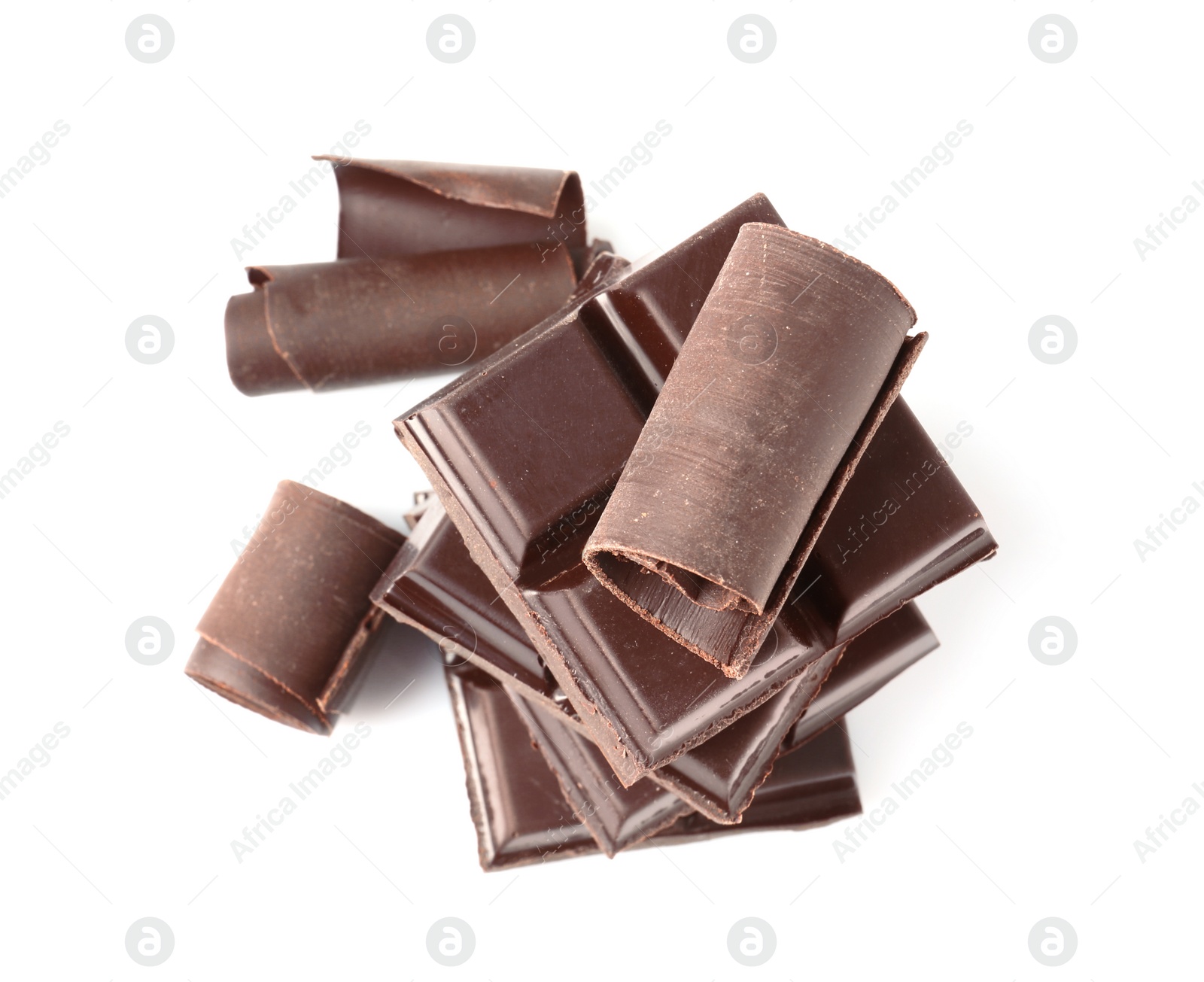 Photo of Yummy chocolate curls and pieces on white background, top view