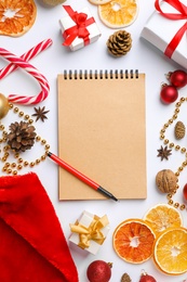 Flat lay composition with notebook and Christmas decor on white background. Letter for Santa Claus