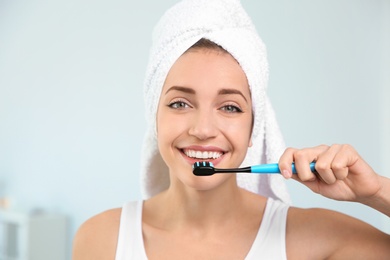 Photo of Portrait of young woman with toothbrush on blurred background