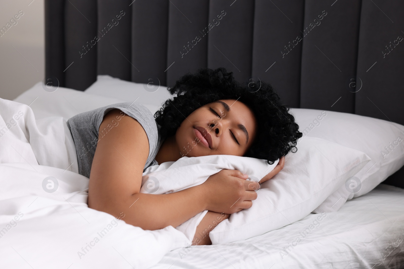 Photo of Beautiful young woman sleeping in soft bed