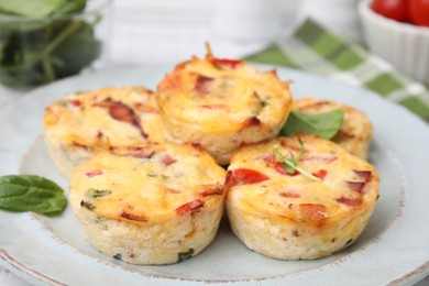 Photo of Delicious egg muffins with cheese and bacon on table, closeup. Space for text