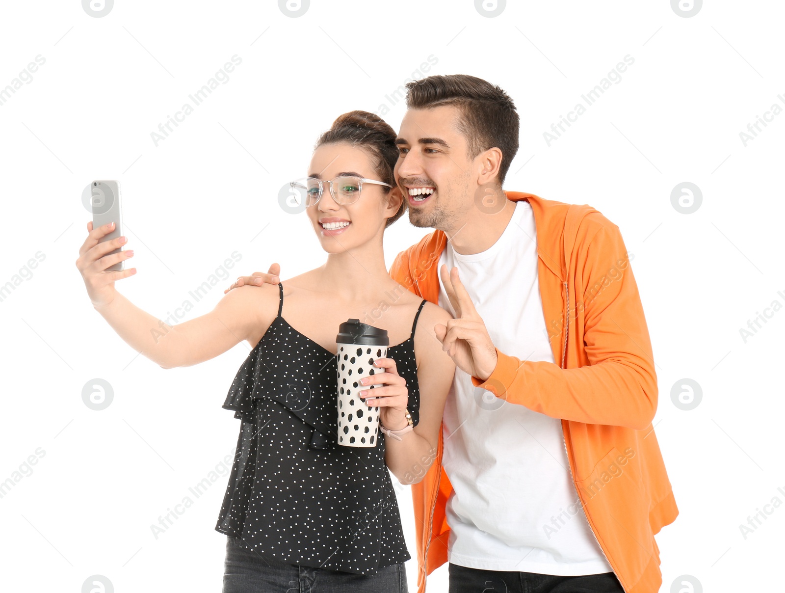 Photo of Young lovely couple taking selfie against white background