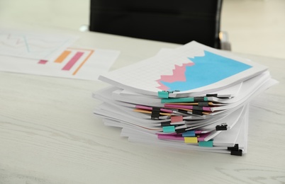 Stack of documents with paper clips on office table. Space for text