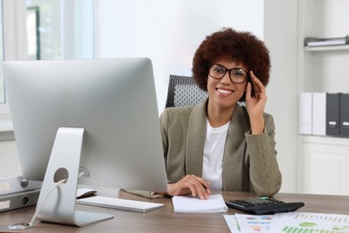 Professional accountant working at wooden desk in office