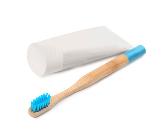 Photo of Bamboo toothbrush and paste isolated on white