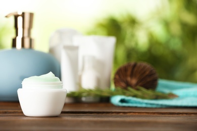 Jar of body care product on table against blurred background. Space for text