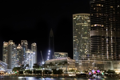 Photo of DUBAI, UNITED ARAB EMIRATES - NOVEMBER 04, 2018: Night cityscape with illuminated buildings
